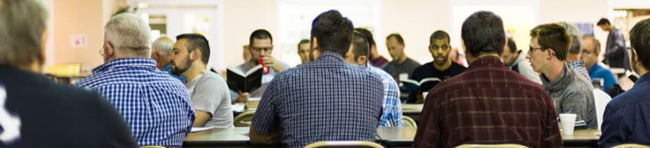 Men studying together around tables