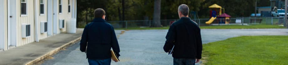 Two men walking together at the camp